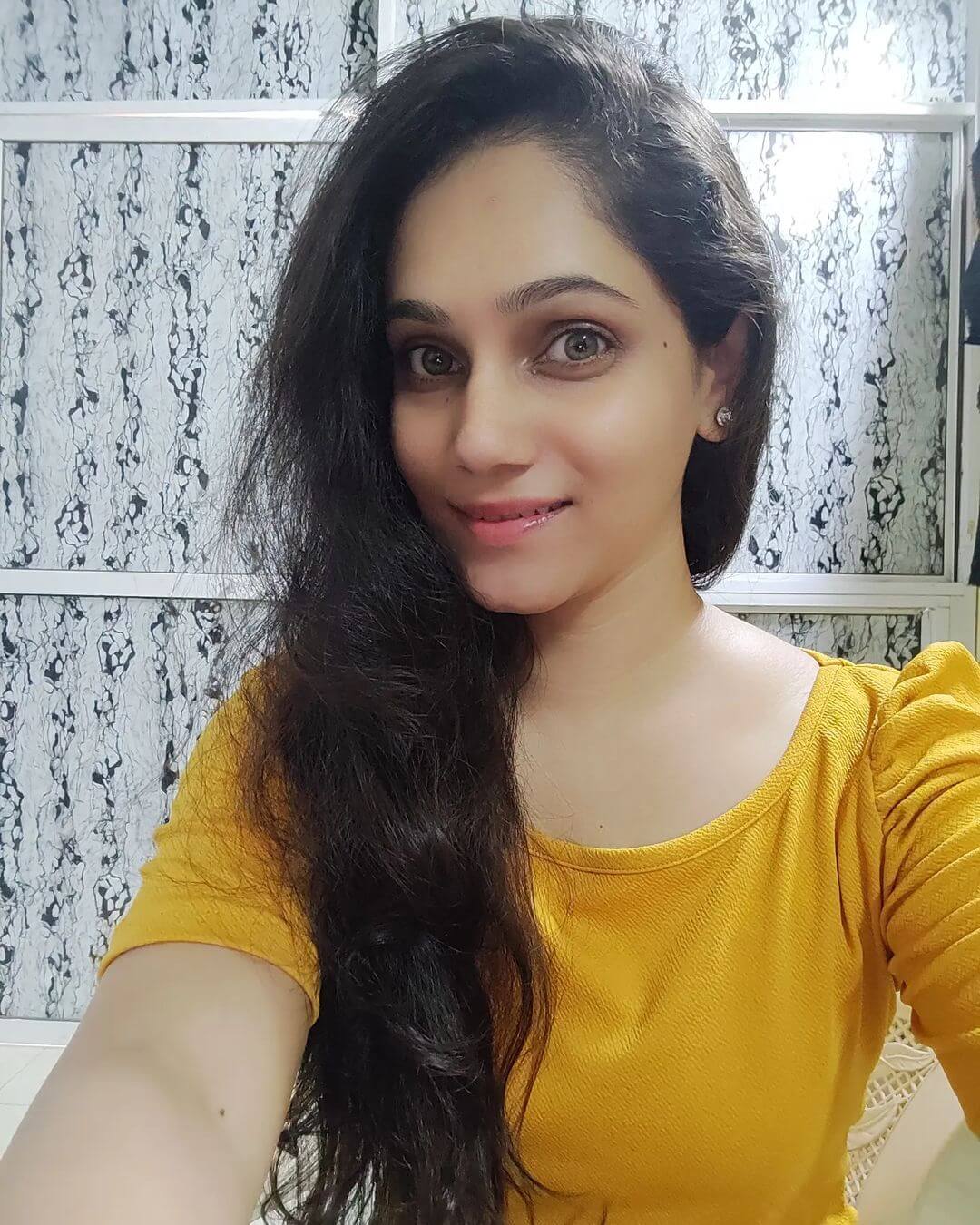 Actress Bageshree Deshpande close up shot in yellow outfit
