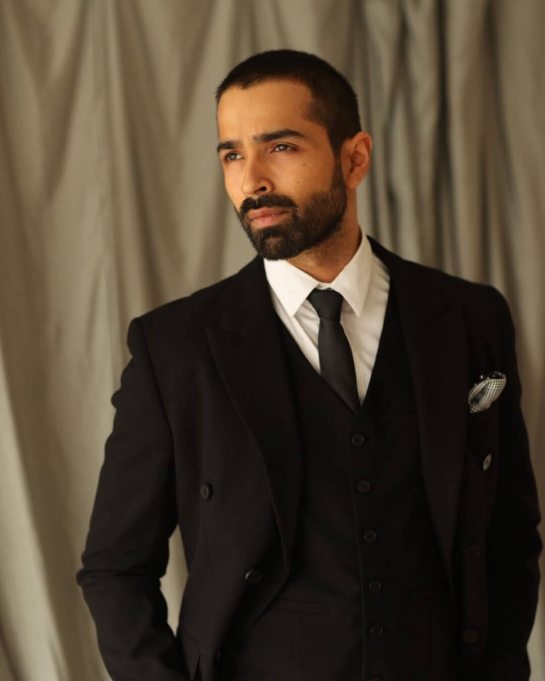 Actor Varun Mitra in black suit