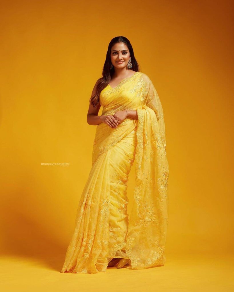 Actress Aditi in yellow saree and sleeveless blouse