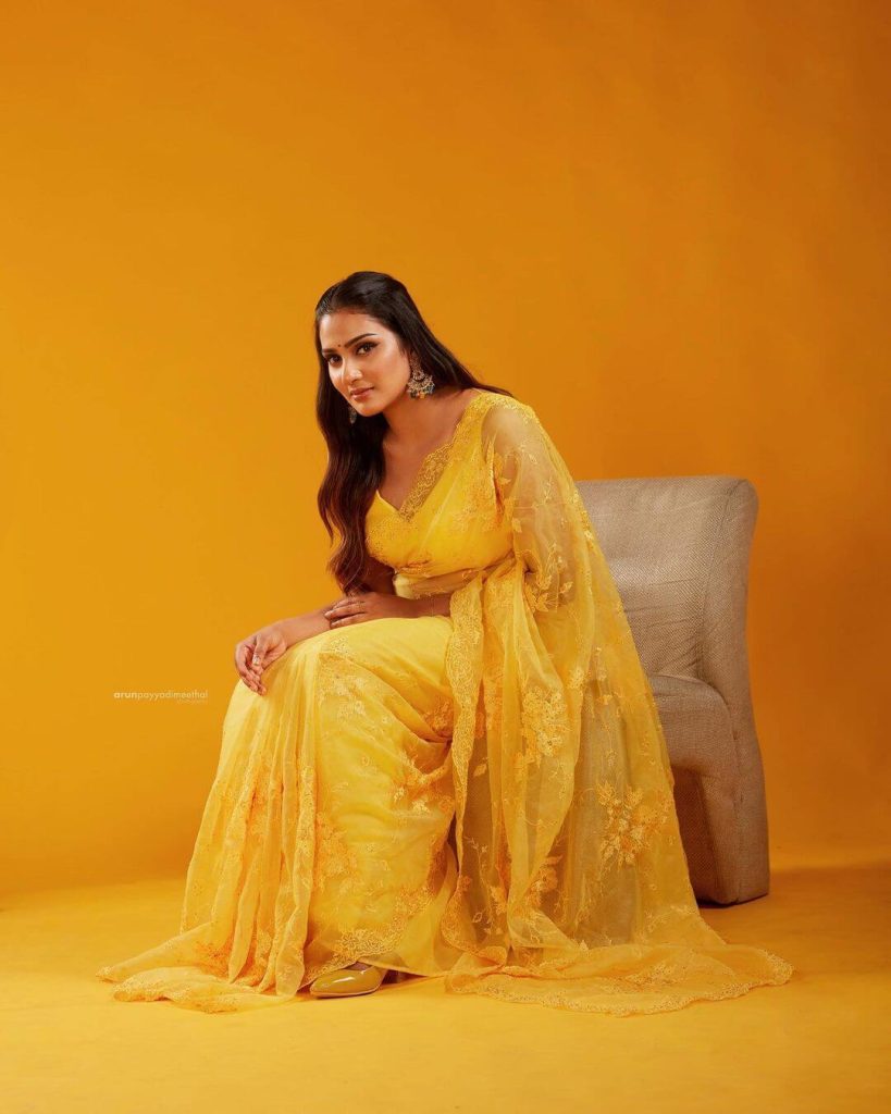 Actress Aditi in yellow saree and sleeveless blouse
