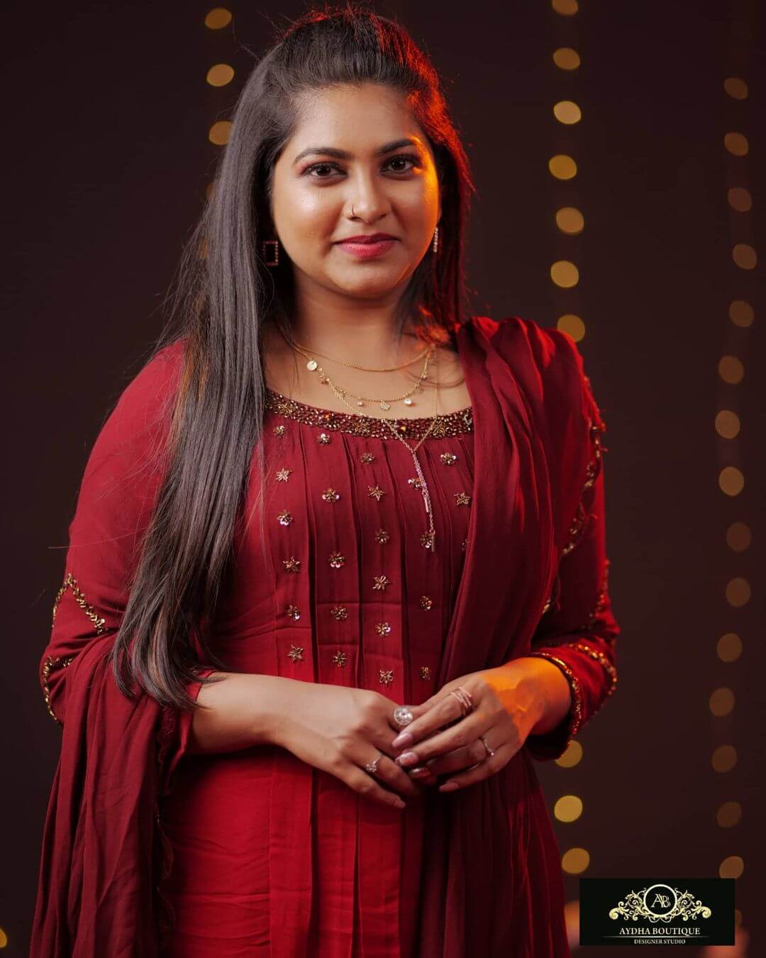 Actress Ankhitha Vinod in dark red salwar