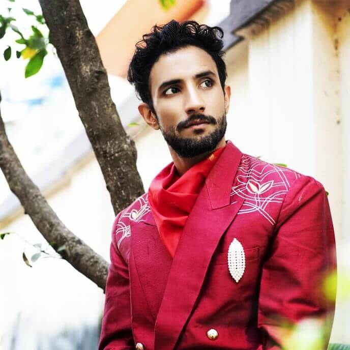 Actor Rishav Basu in red outfit 