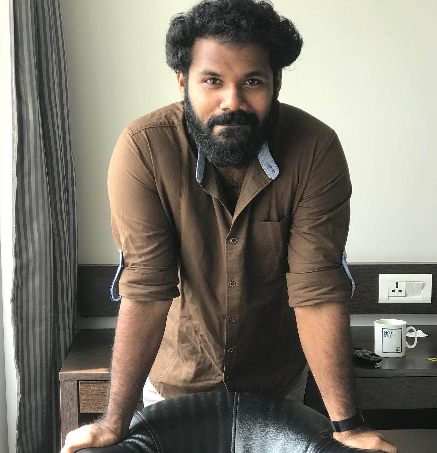 Abhishek Raveendran in light brown shirt
