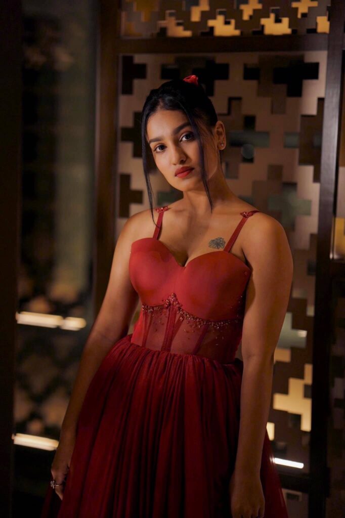 Actress Saniya Iyappan in sexy red outfit showing tattoo