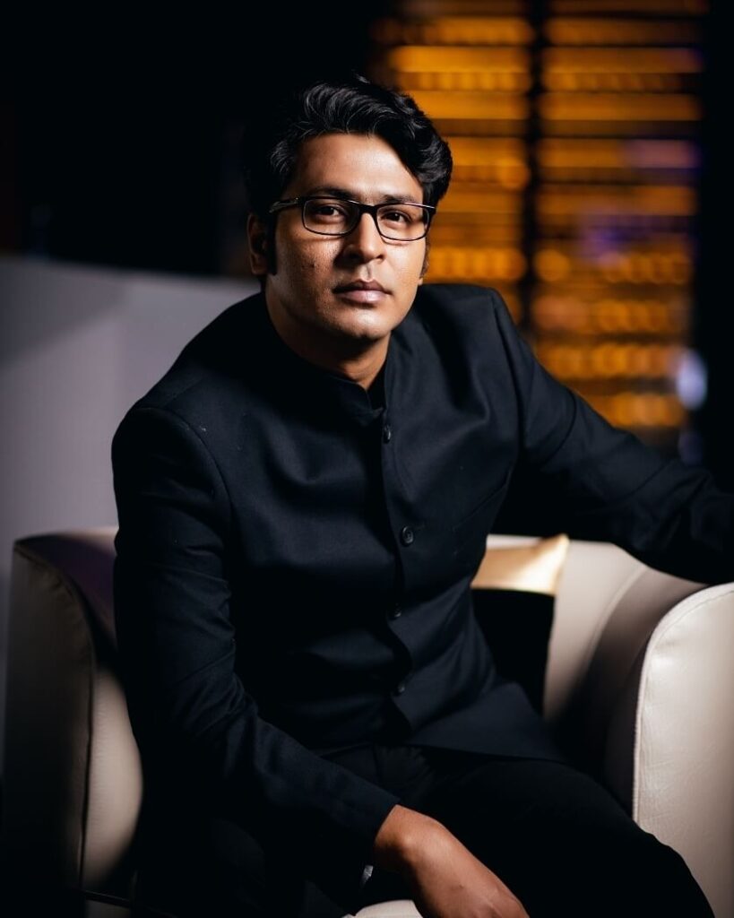 Anirban Bhattacharya in black suit