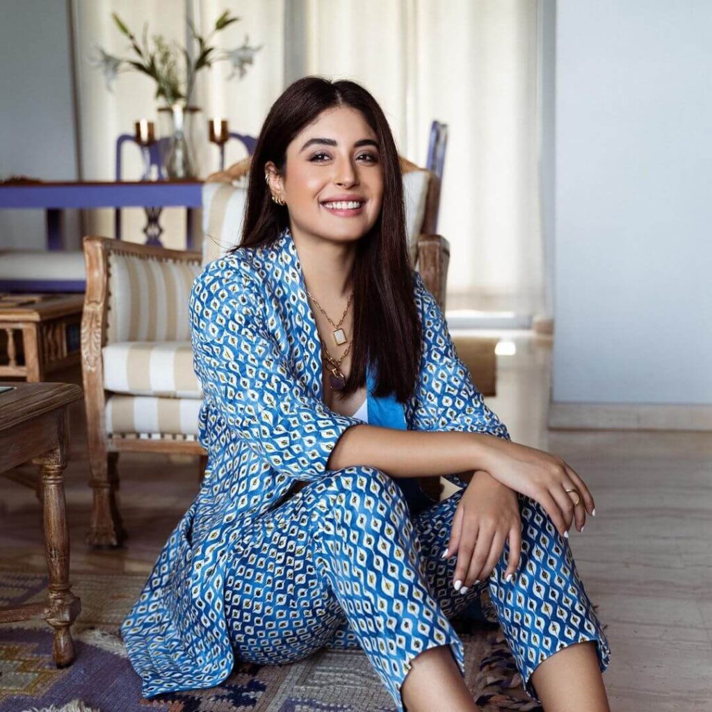 Kritika Kamra sitting in blue pattern outfit