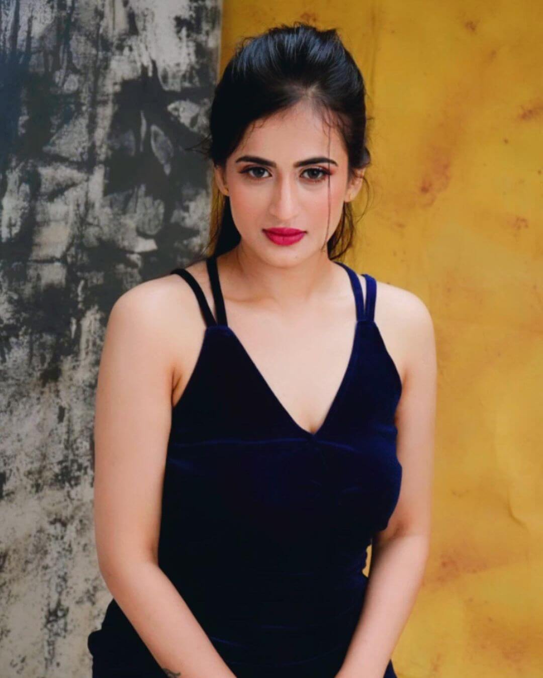 Actress Thapaswini Poonacha in sexy sleeveless dark blue gown