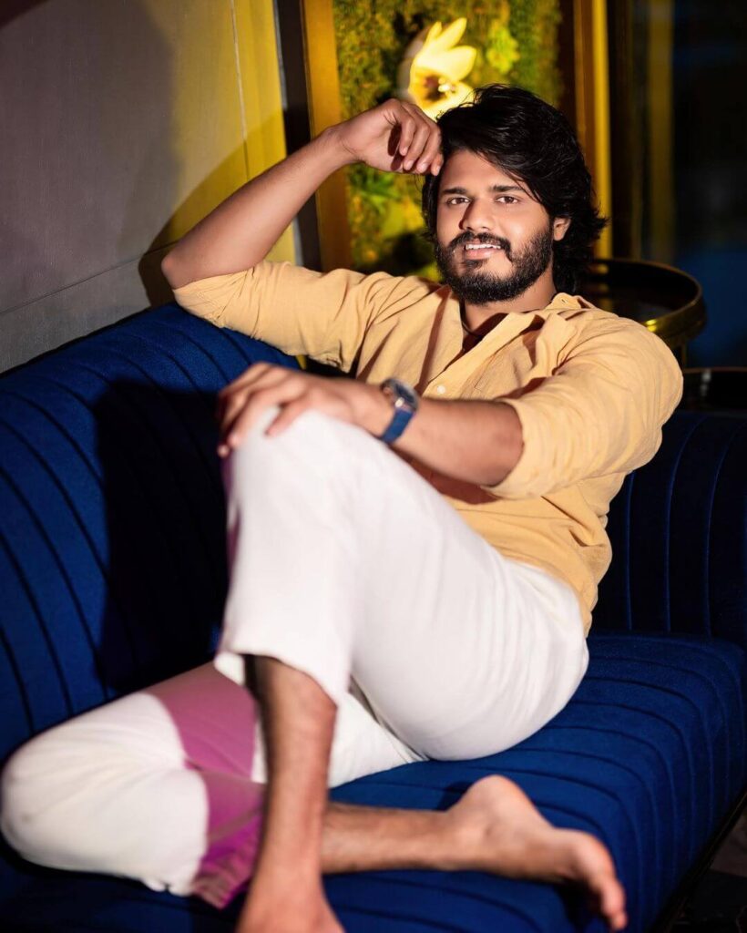 Anand Deverakonda sitting in stylish look