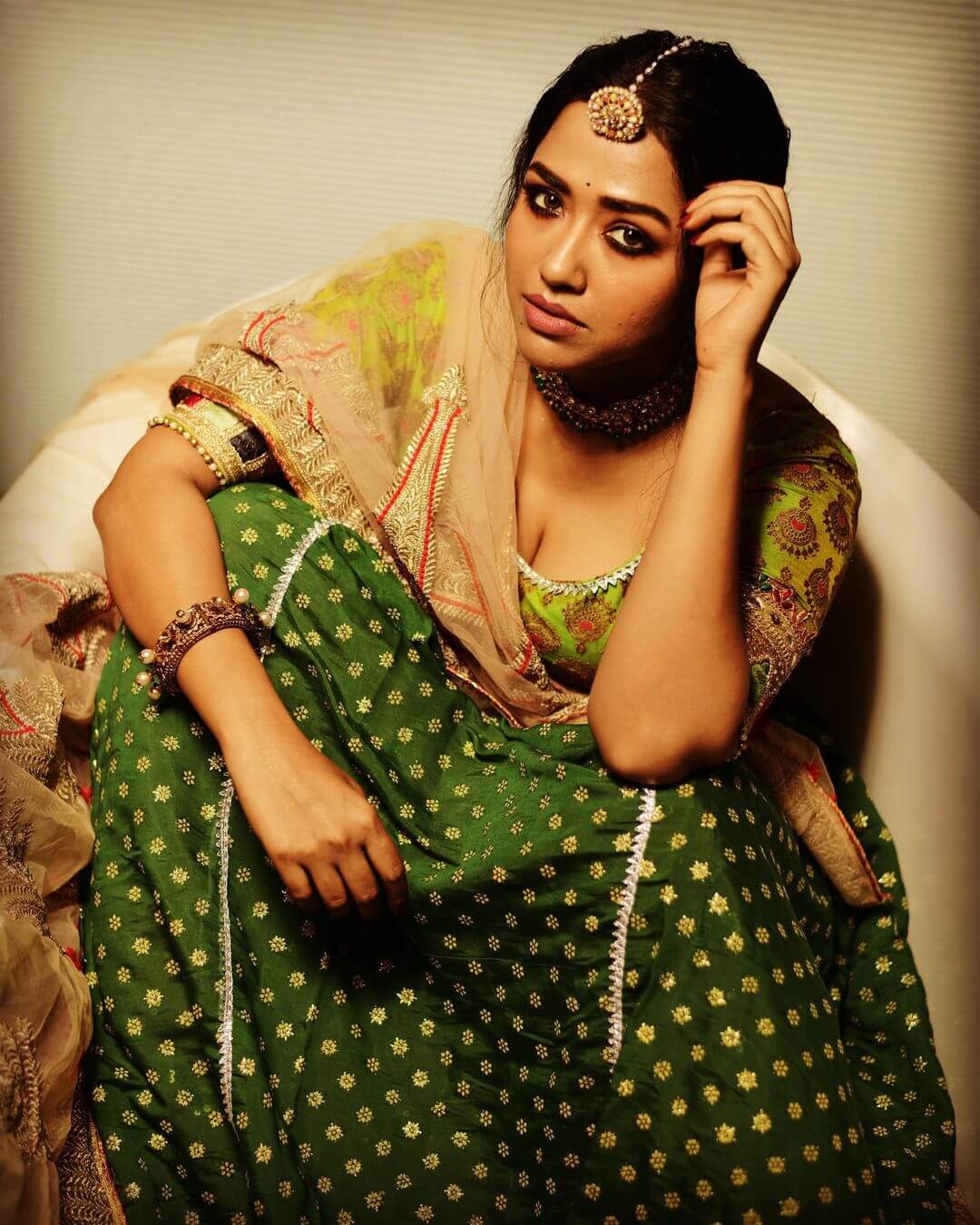 Sohini Sarkar sitting in dark green outfit