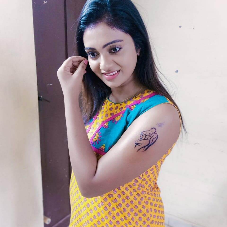 Sunitha side shot showing tattoo
