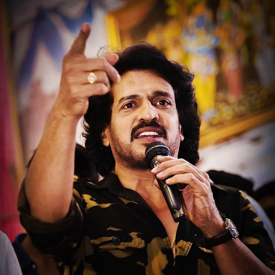 Upendra close up shot with a mic in  hand