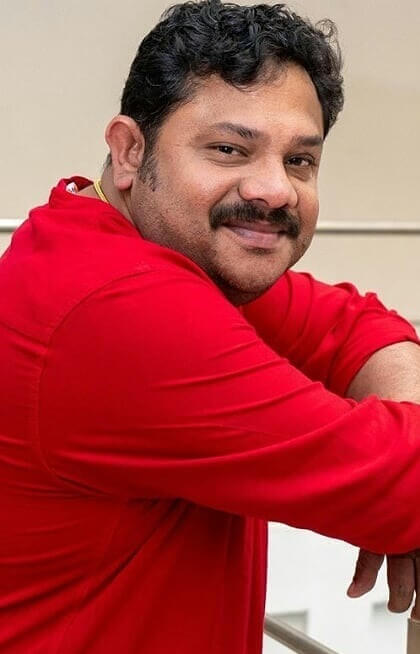 Actor Hareesh Kanaran close up shot in red shirt