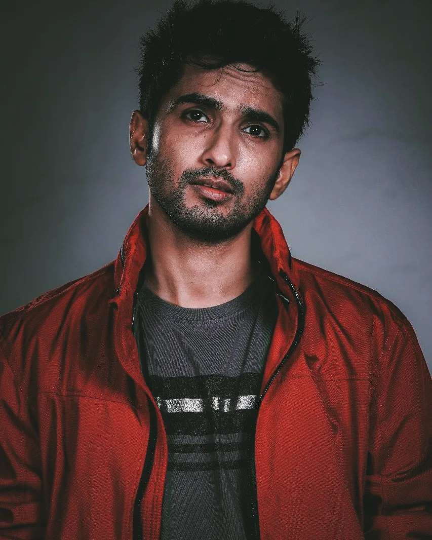 Actor Anud Singh Dhaka close up shot in red jacket