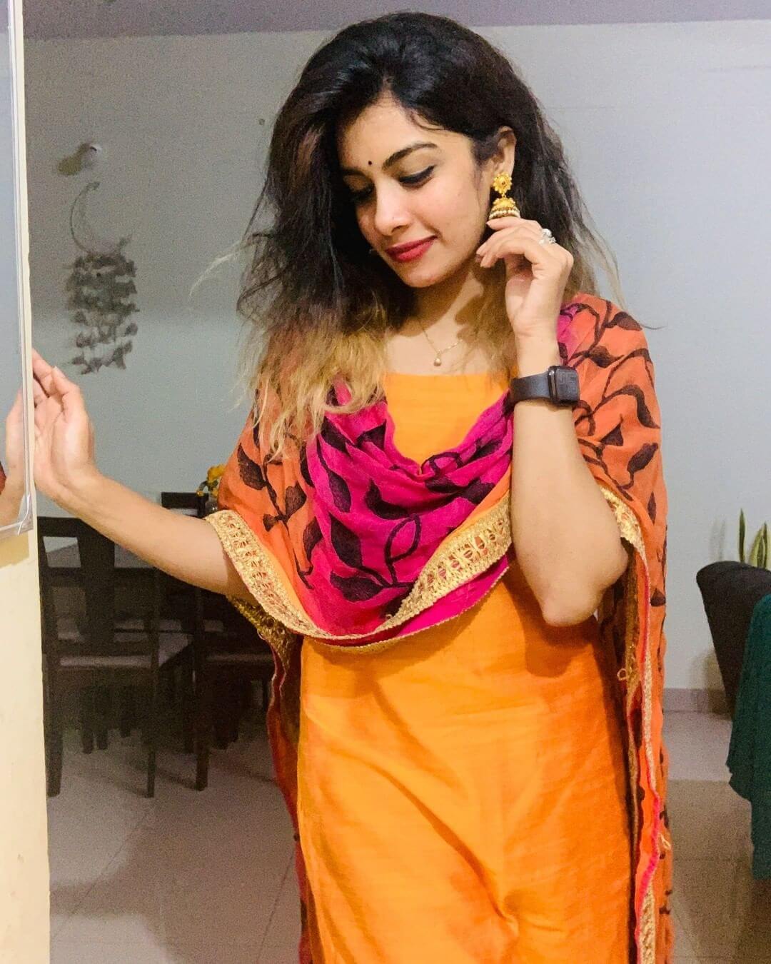 Dilsha Prasannan in orange salwar