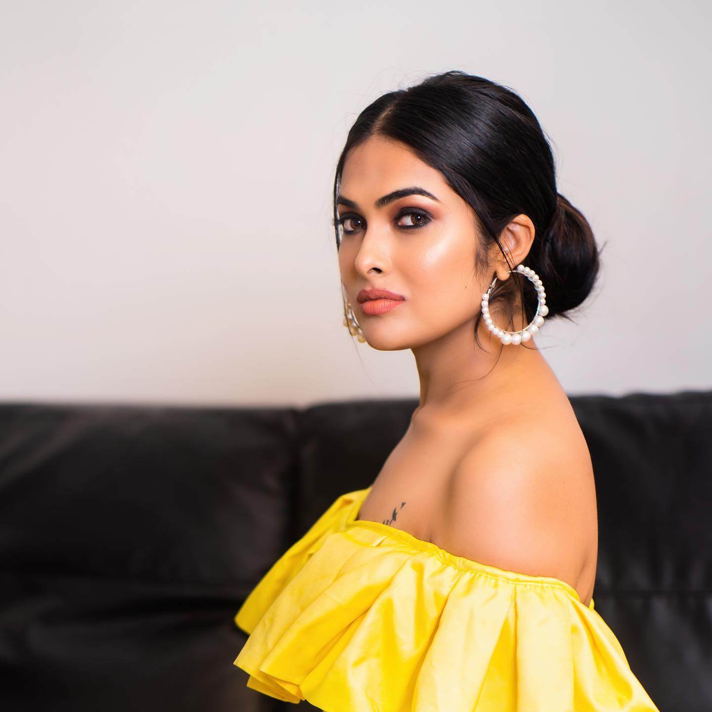 Actress Divi Vadthya close up shot in yellow sexy outfit