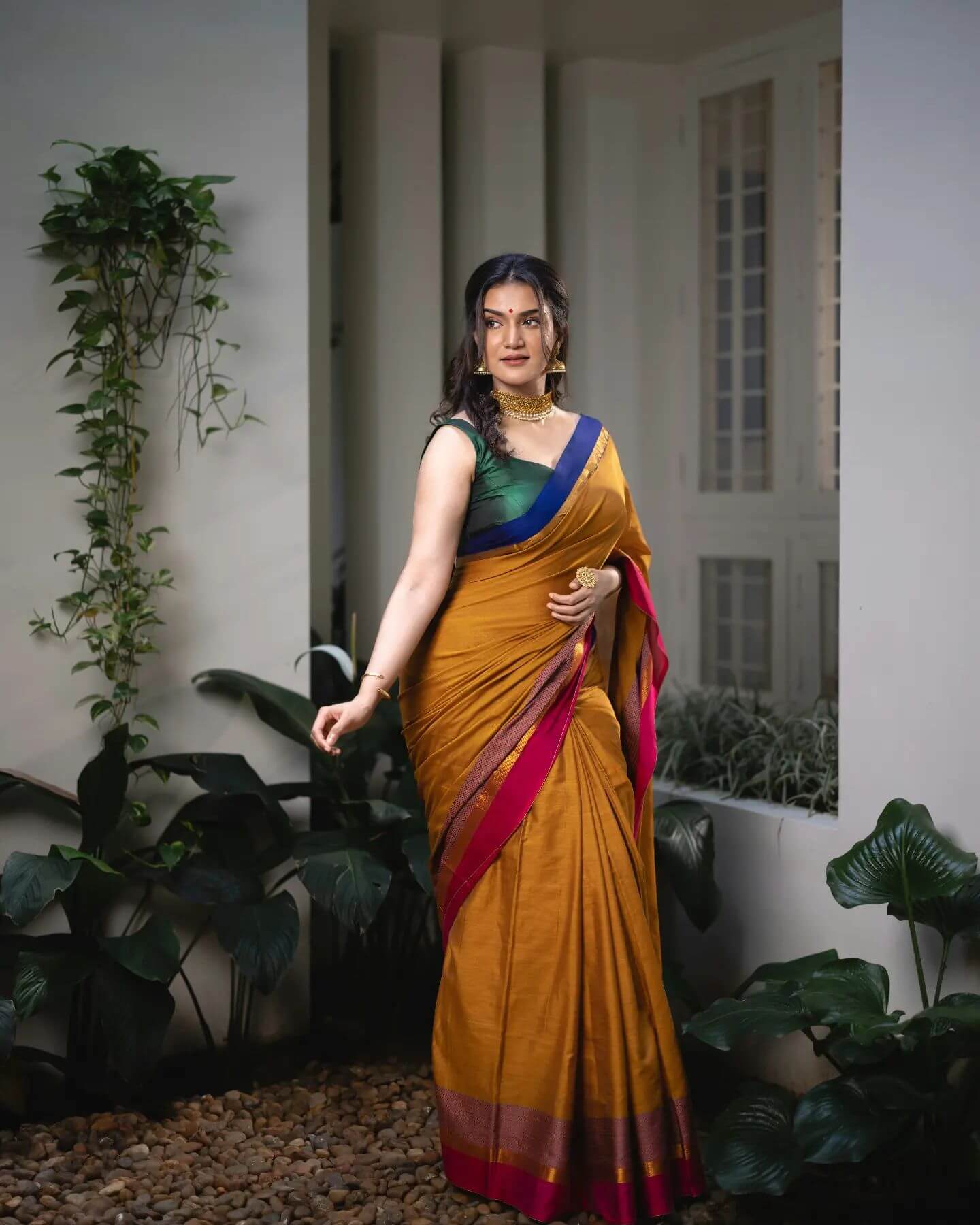 Actress Honey Rose in golden color saree and sleeveless dark green blows