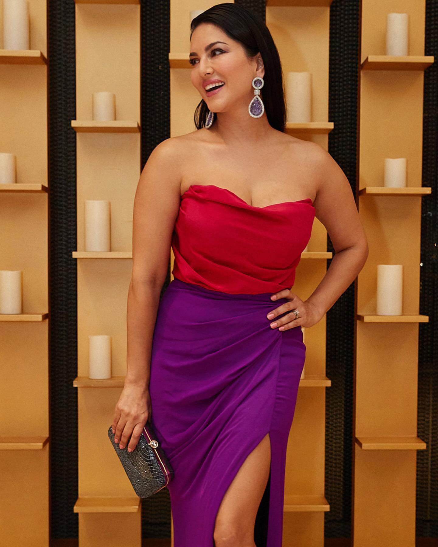 Actress Sunny Leone in red and violet sexy outfit