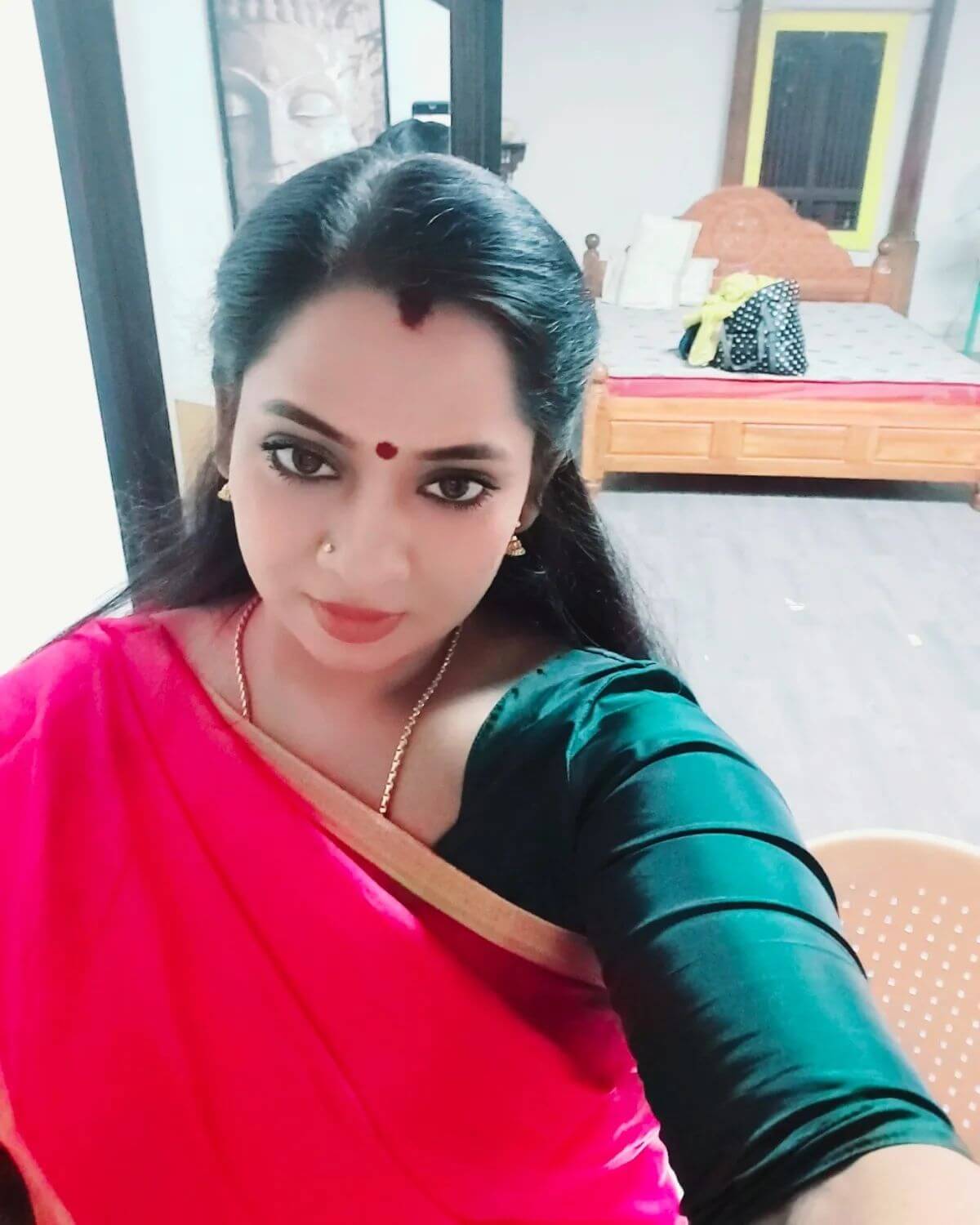 Actress Tamil Selvi close up shot in red saree and dark green blows