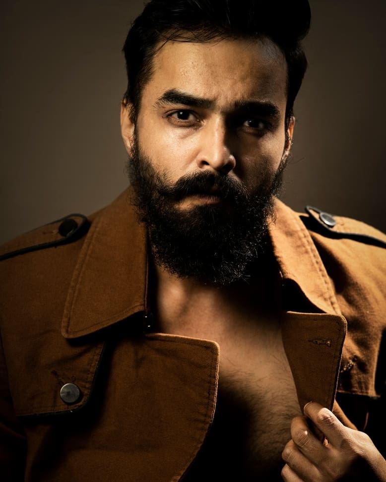 Actor Vivek Simha close up shot in brown jacket