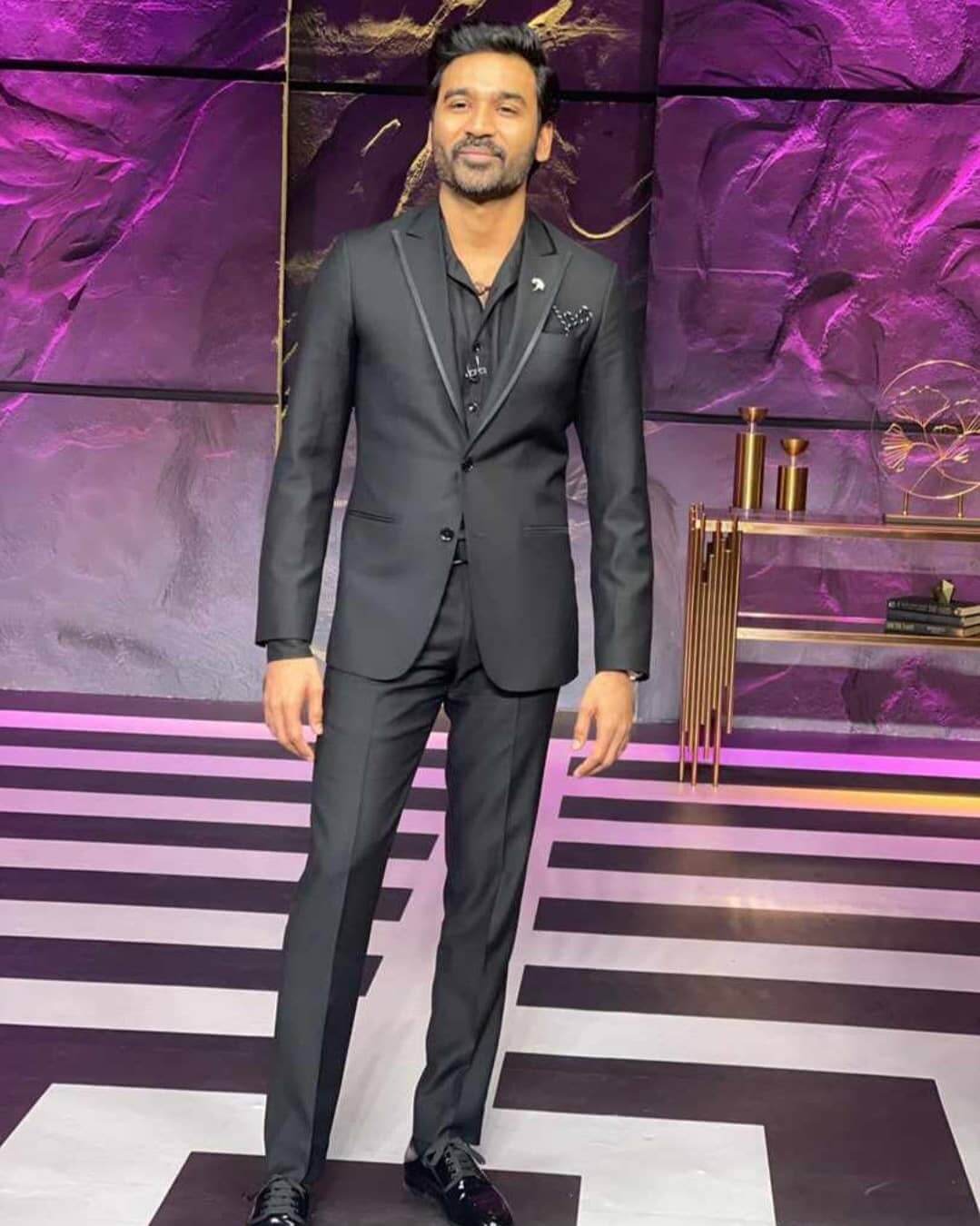 Actor Dhanush in black suit