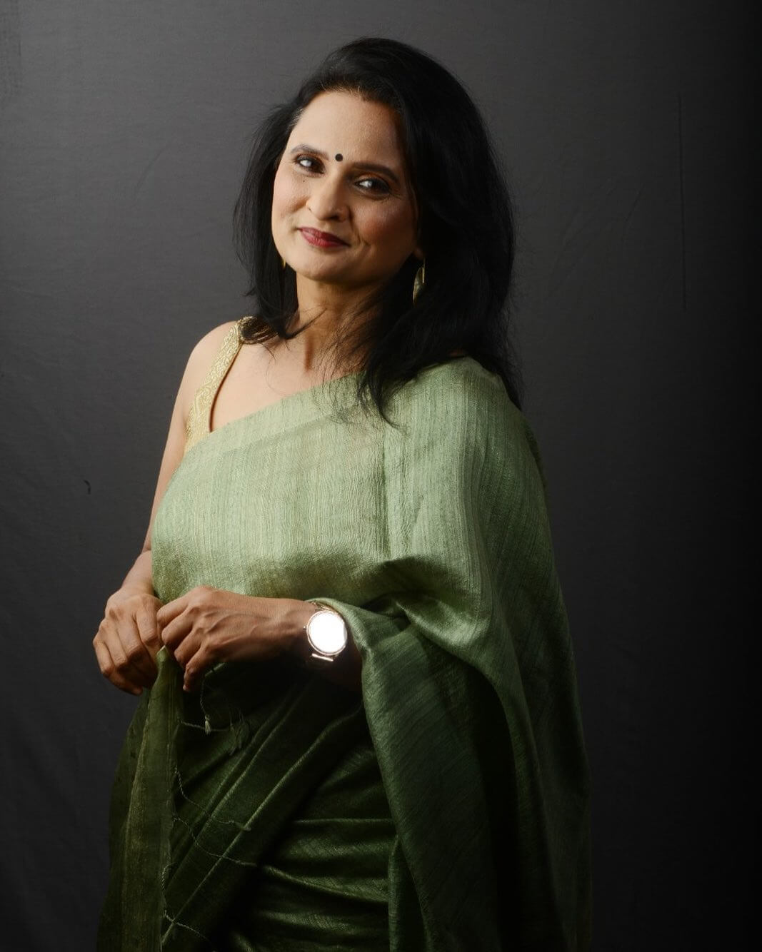 Actress Geetanjali Kulkarni in dark green saree