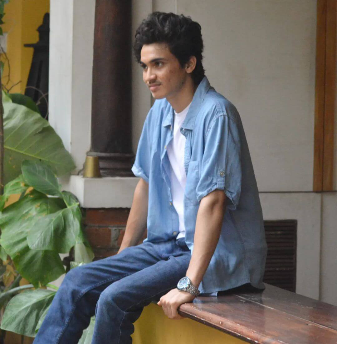Actor Pranav Prasanth sitting in sky blue shirt