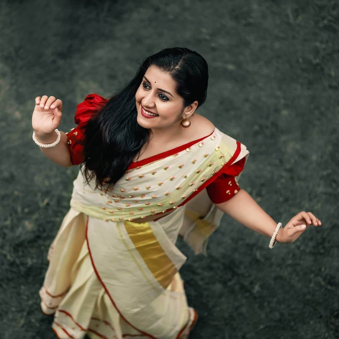 Actress Sarayu Mohan in red and cream color saree
