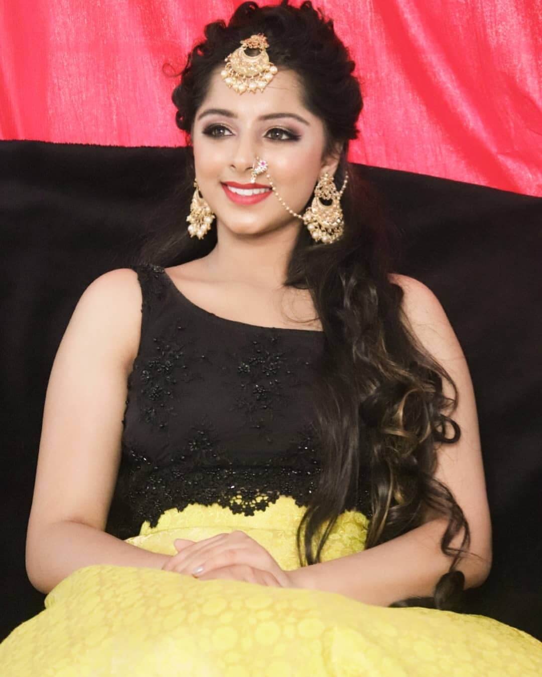 Actress Vaishnavi close up shot in black and yellow outfit