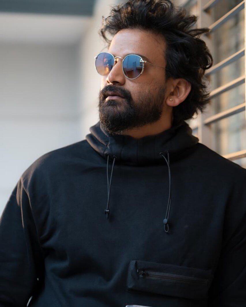 Actor Daali Dhananjaya close up in black hoody
