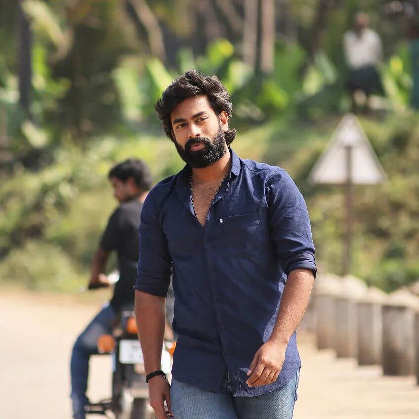 Actor Atluri Rakshit in dark blue shirt