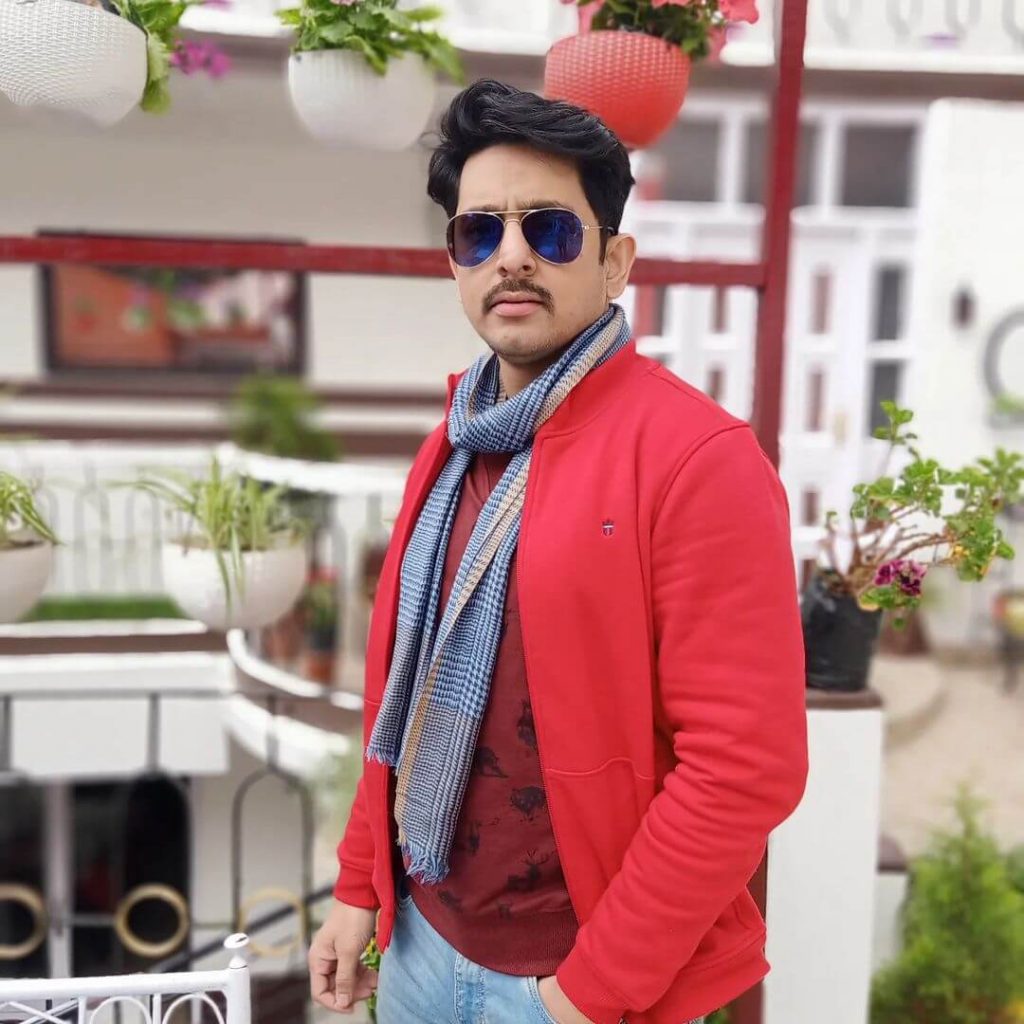 Actor Mainak Banerjee close up in red jacket