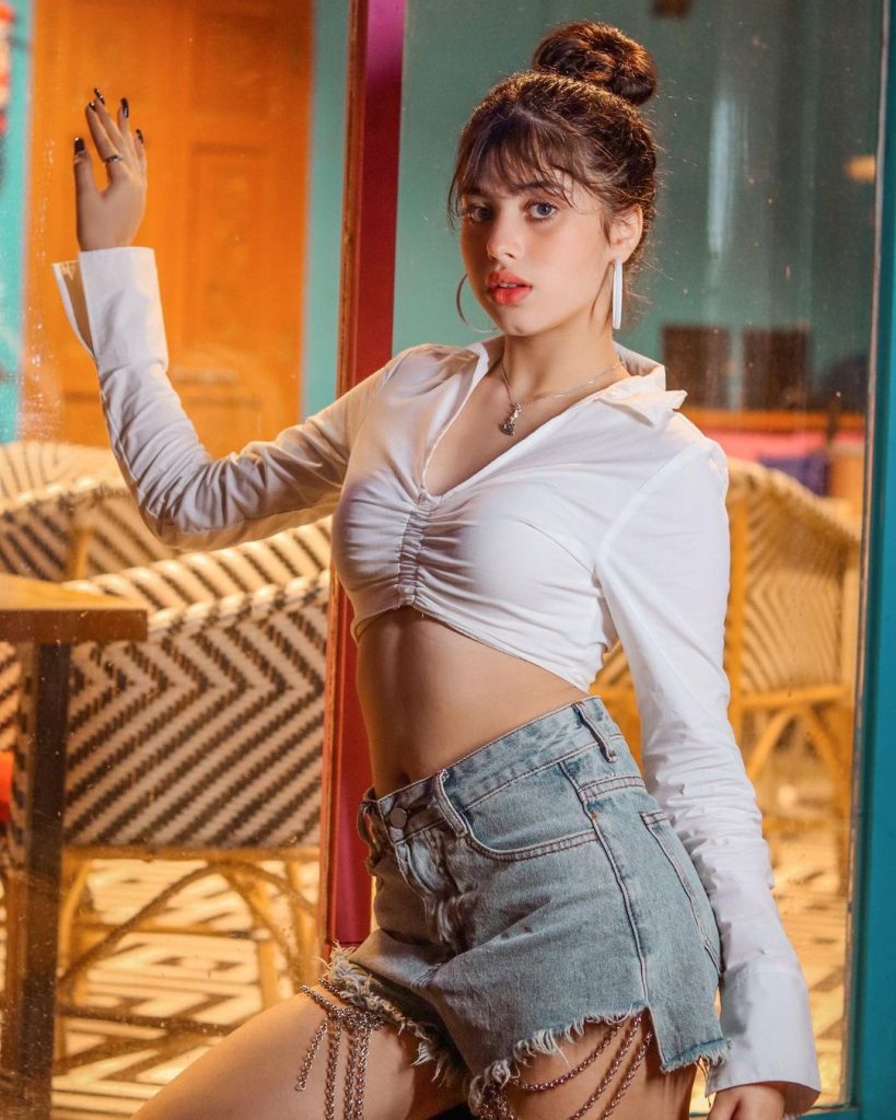 Actress Riva Arora in sexy white top and gray shorts