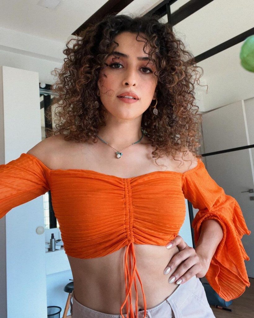Actress Sanya Malhotra sexy close up in orange outfit