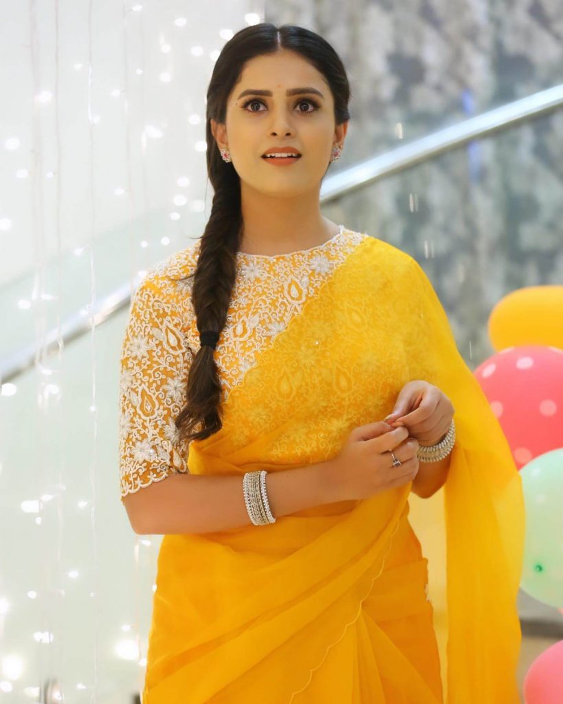 Actress Thanuja Puttaswamy close up in yellow saree