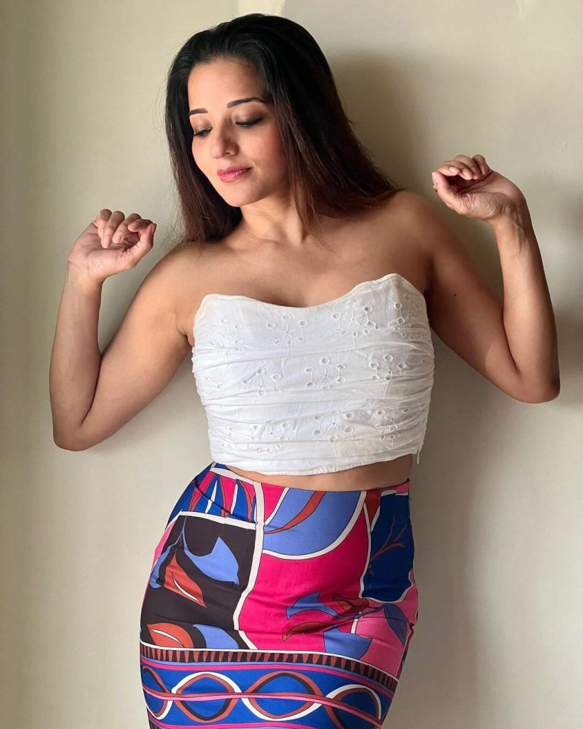 Actress Monalisa in a white crop tube top paired with a stylish multi-color floral print short-line skirt