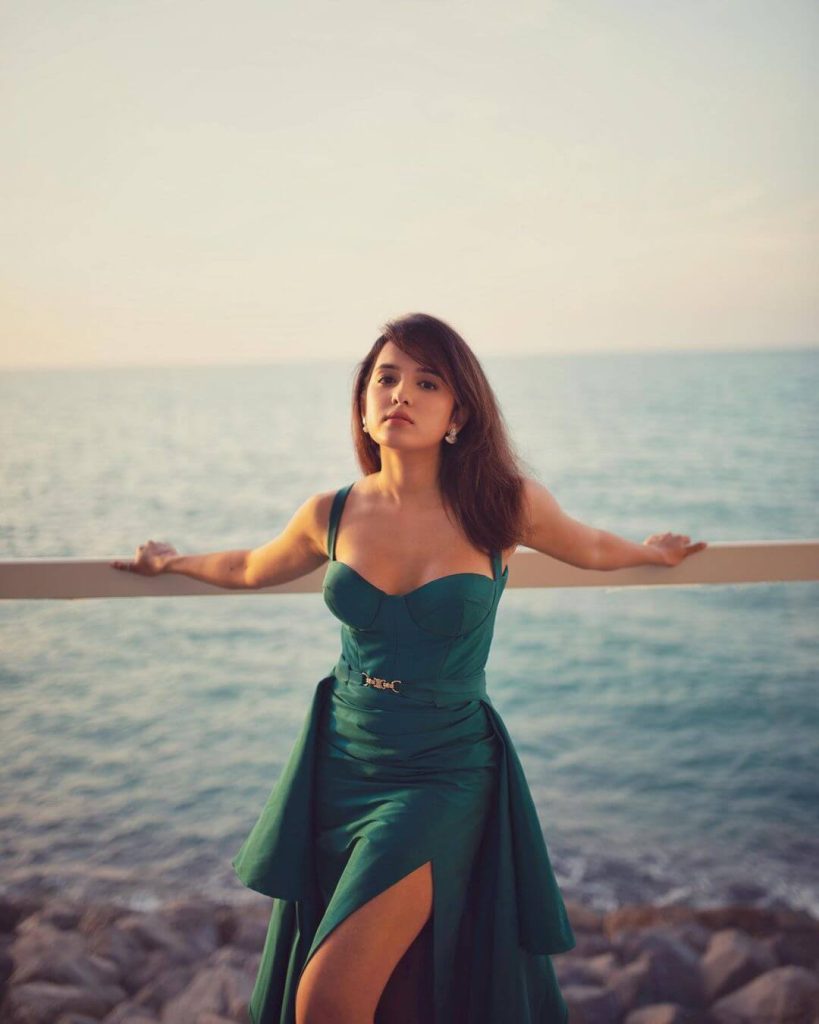 Actress Shirley Setia in thigh-high slit blue tulle gown with a belted floor-sweeping draped overskirt